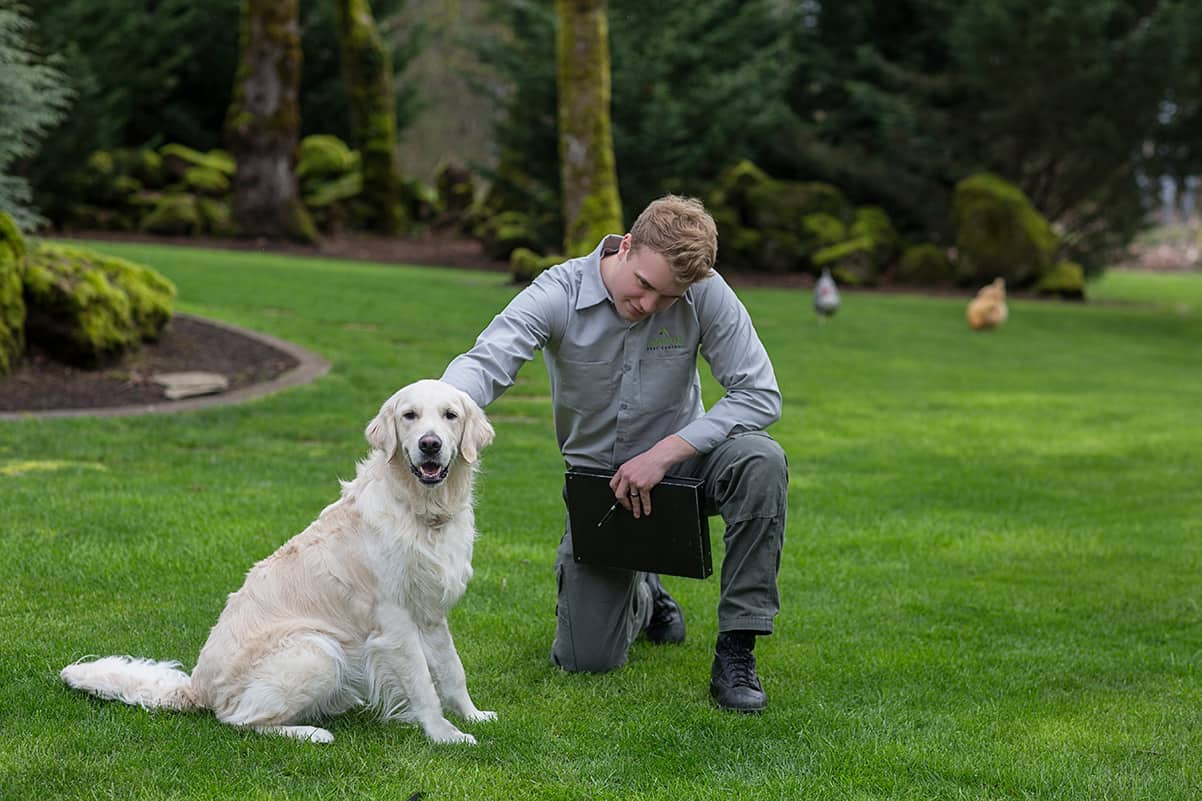 image of oregon city pest control technician petting client's dog