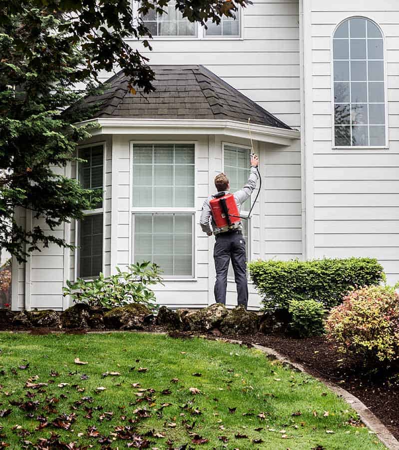 Aspen Pest Control Technician Treating a Vancouver WA Yard with Green Pest Control Product